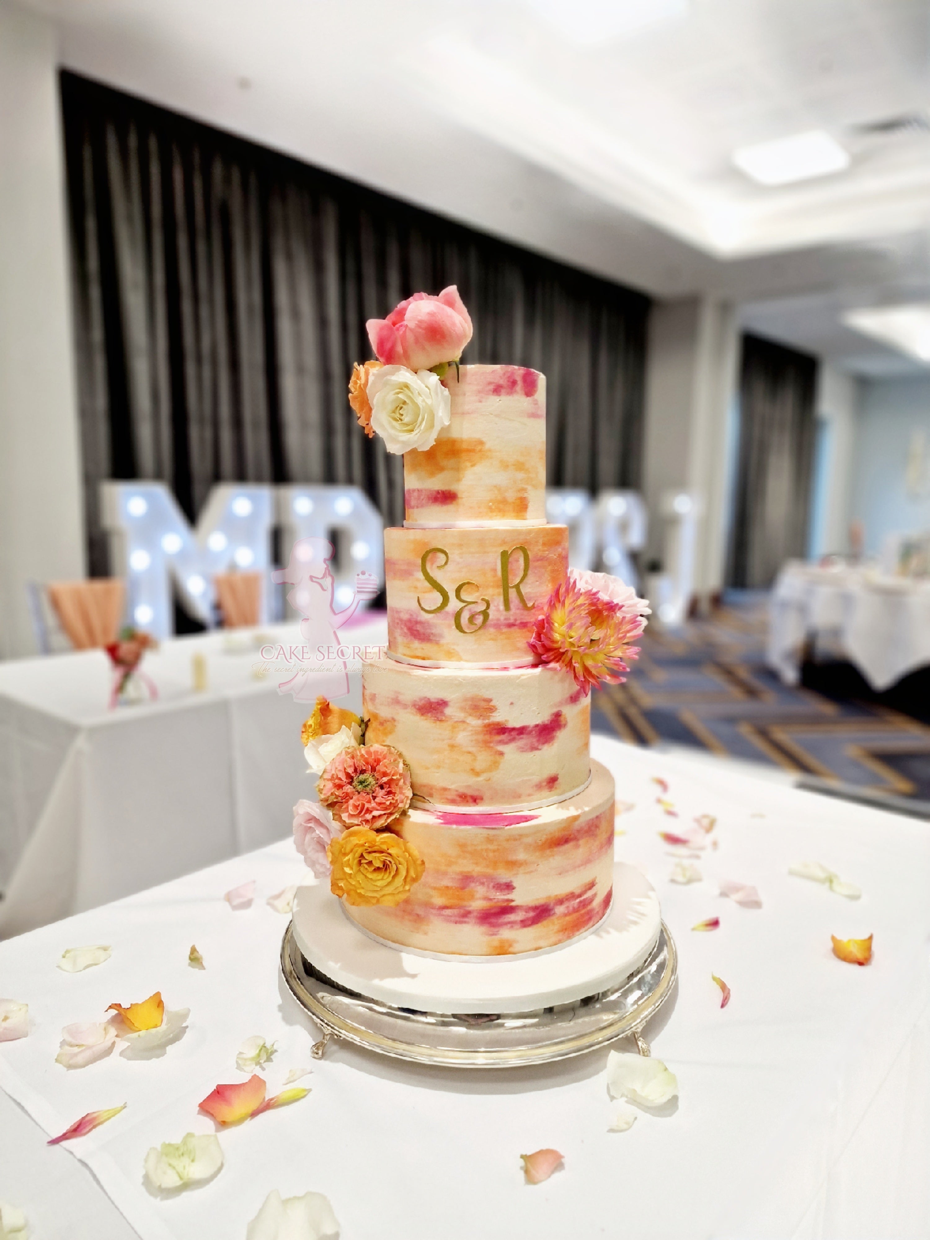 Vibrant Bliss Bright Orange and Deep Pink Textured Buttercream Wedding Cake with Fresh Flowers - Cake Secret