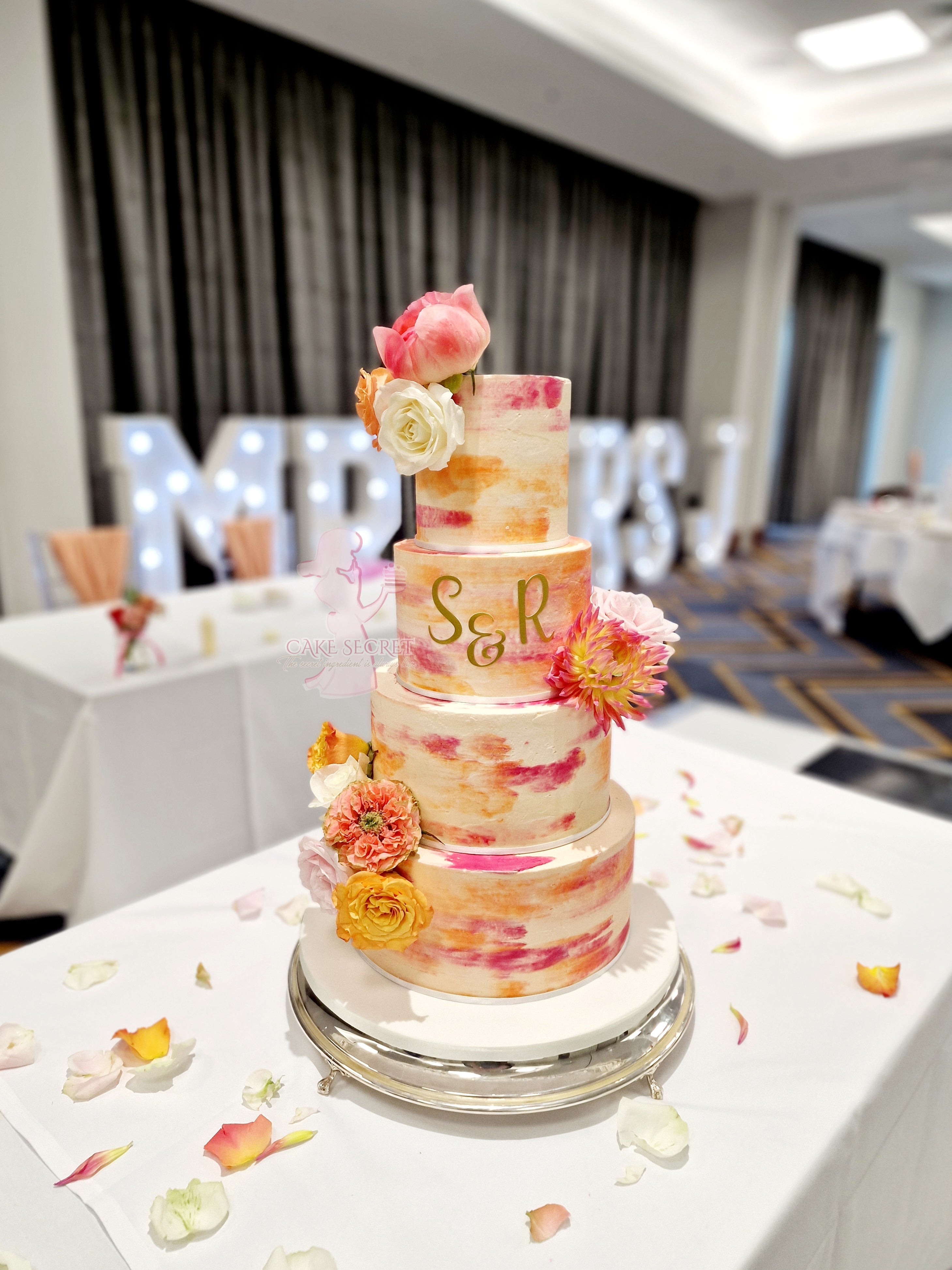 Vibrant Bliss Bright Orange and Deep Pink Textured Buttercream Wedding Cake with Fresh Flowers - Cake Secret